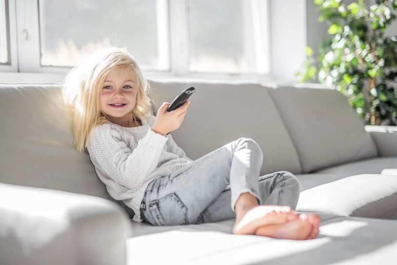 smiling-girl-with-remote-controller.JPG